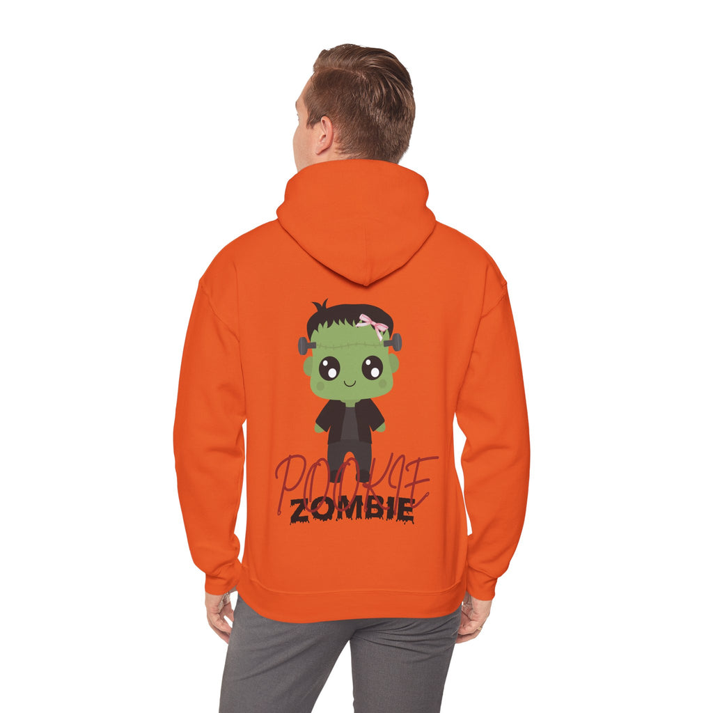 Person wearing an orange hoodie with a cartoon zombie design on the back