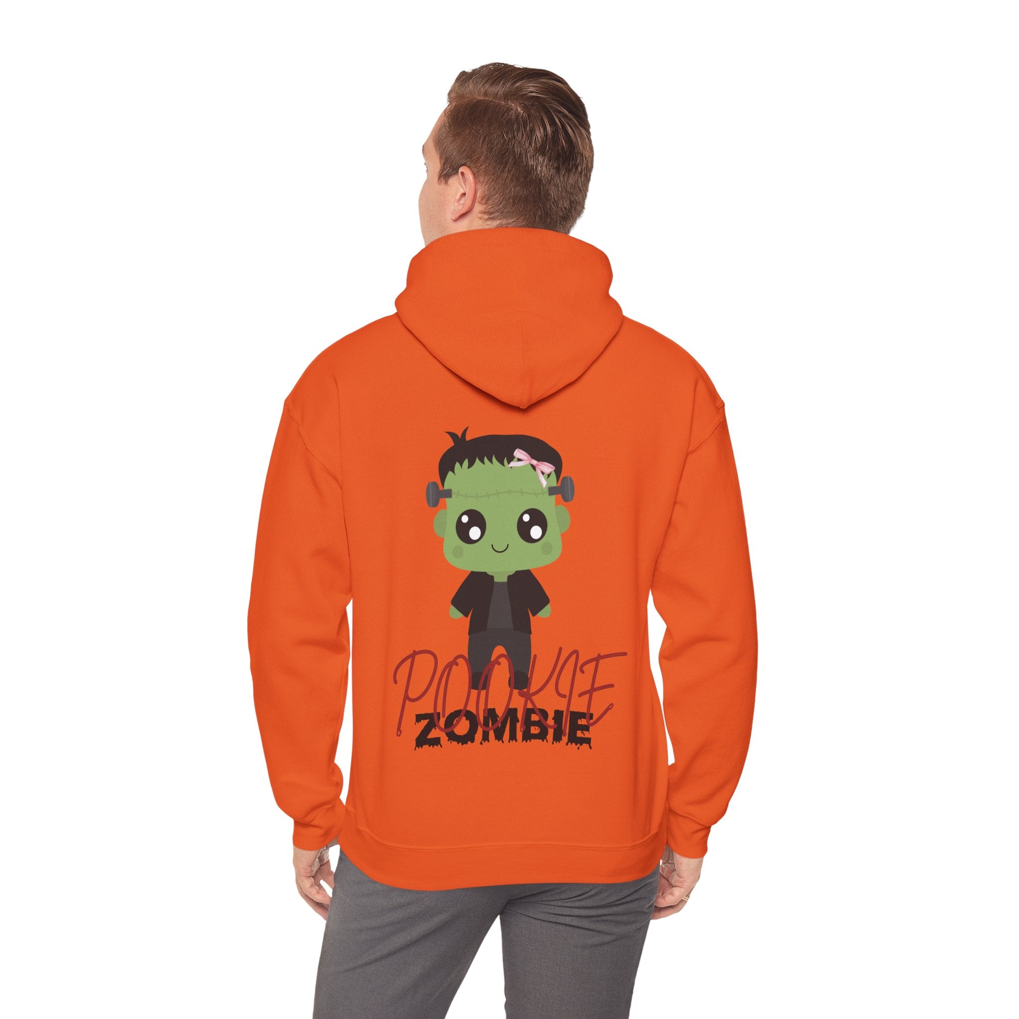 Person wearing an orange hoodie with a cartoon zombie design on the back