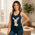 Woman wearing a Solid Midnight navy tank top with a bunny design in a bright room.