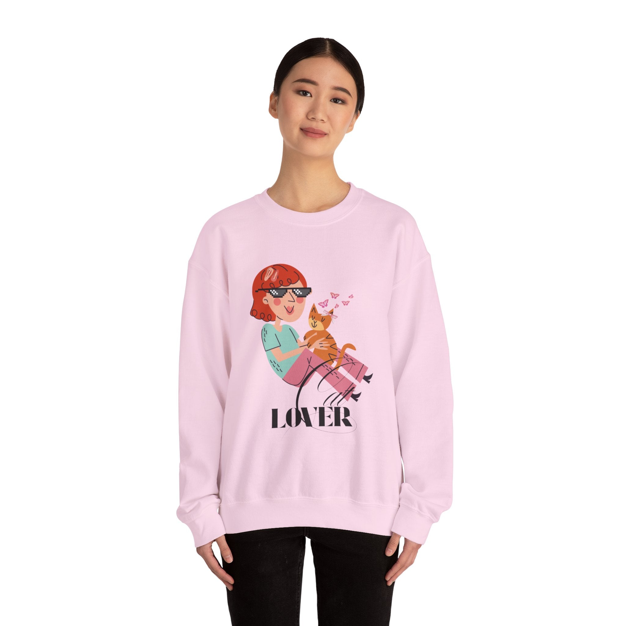 Person wearing a Light pink sweatshirt with a graphic design and the word 'Cat LOVER' on a white background