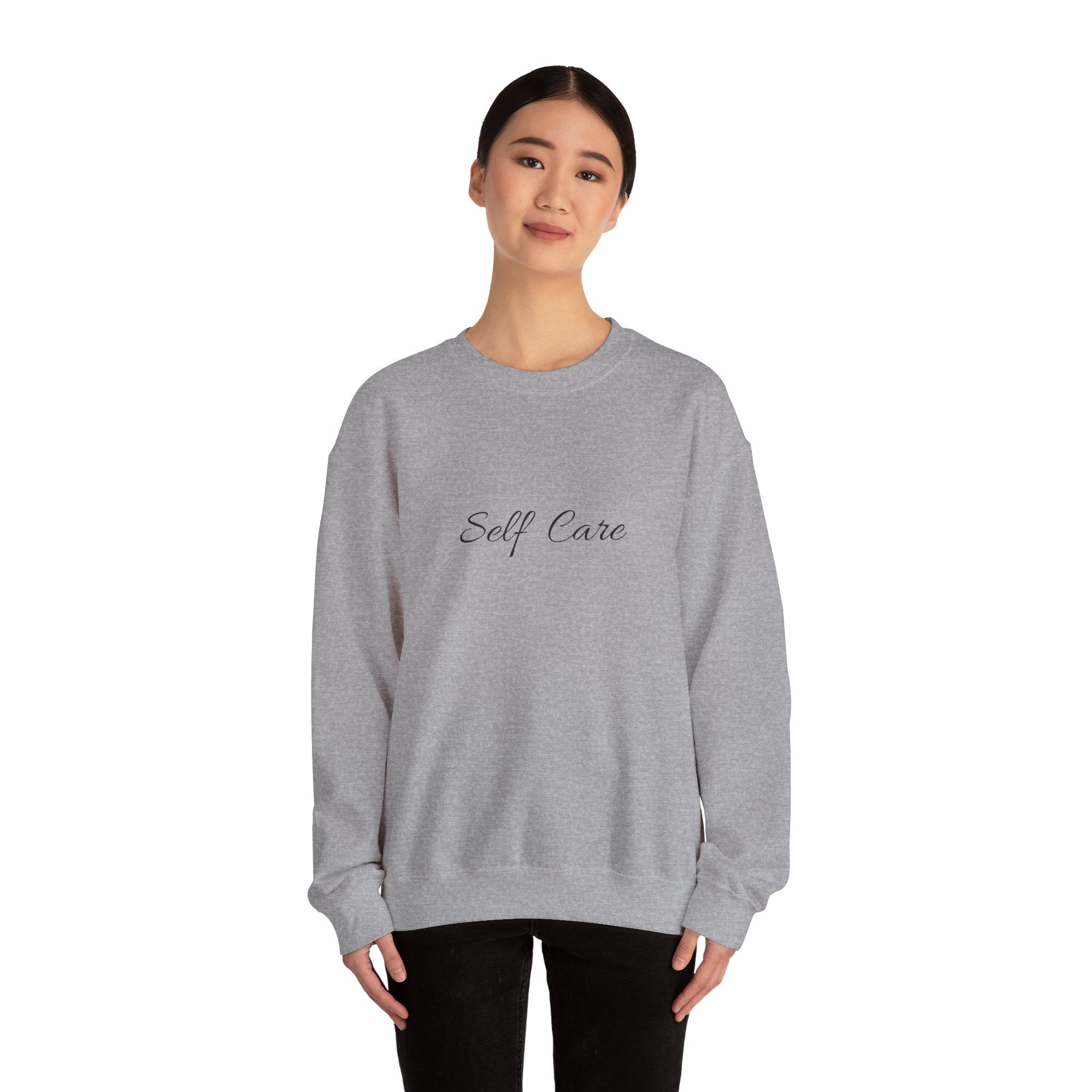Person wearing a Sport gray sweatshirt with 'Self Care' text on a white background