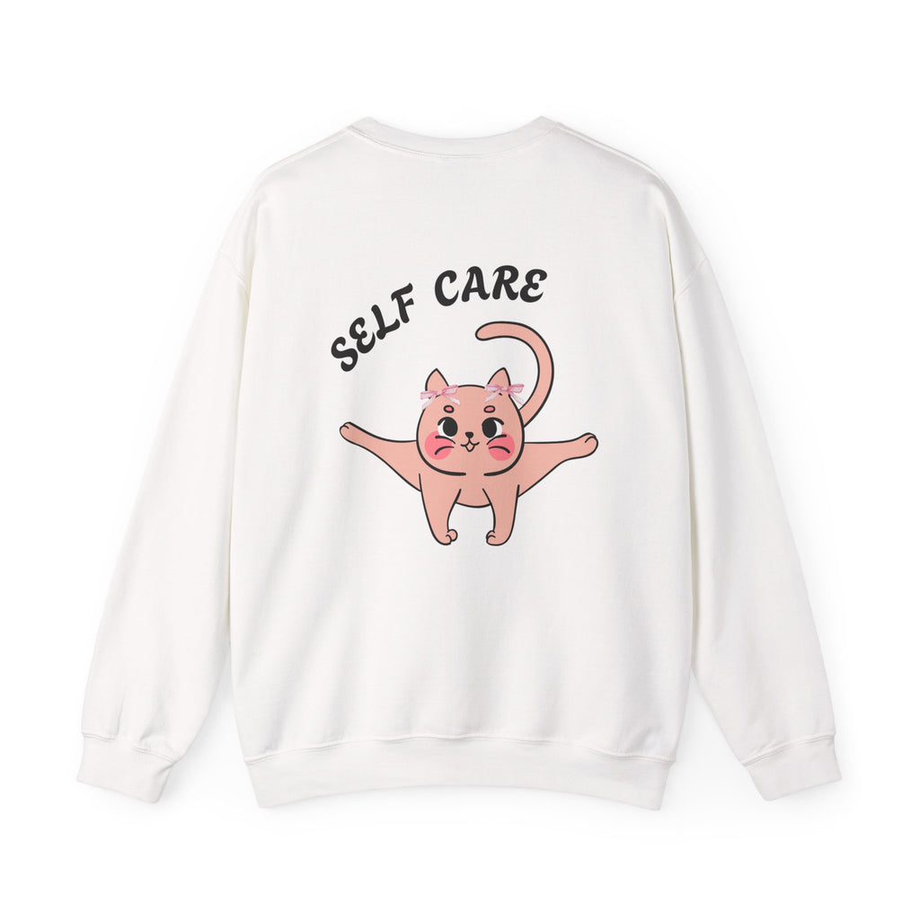 White sweatshirt with a pink cat illustration and 'SELF CARE' text on a white background