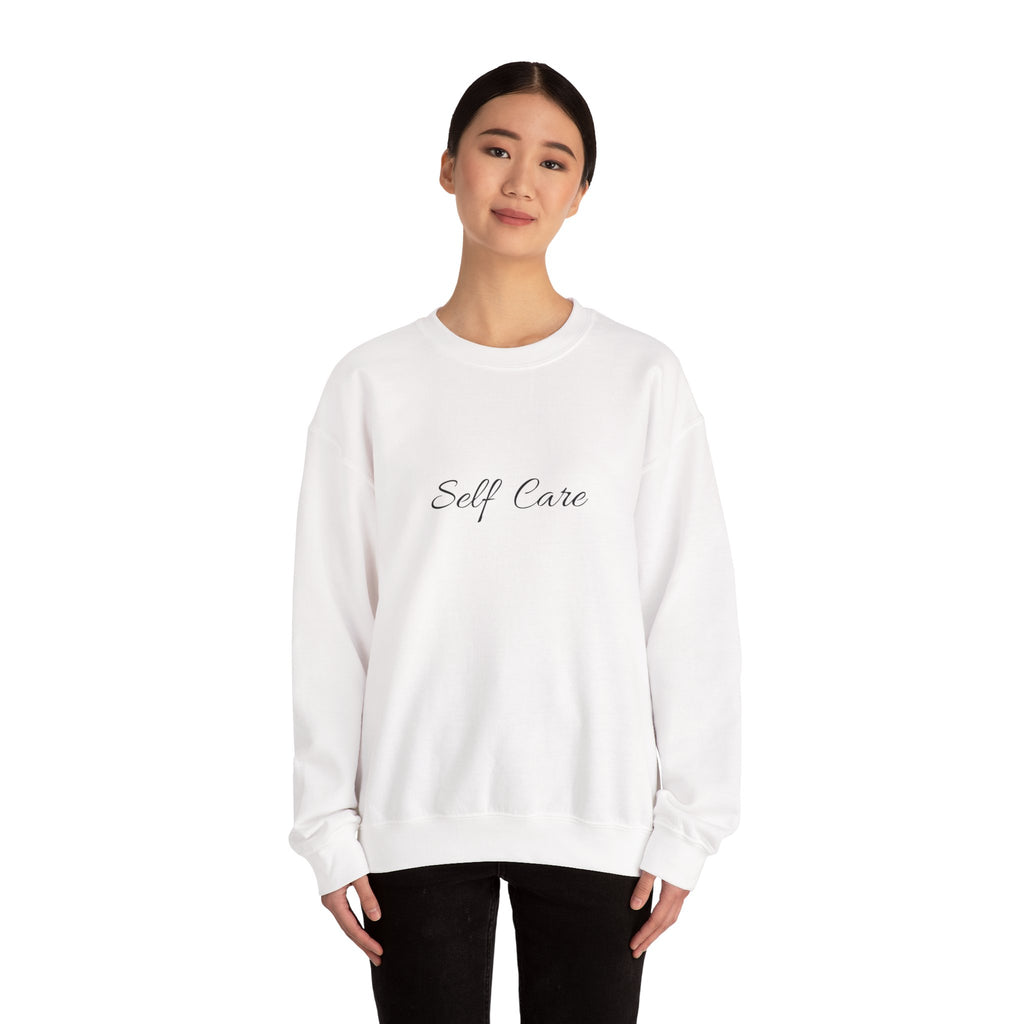 Person wearing a white sweatshirt with 'Self Care' text on a white background