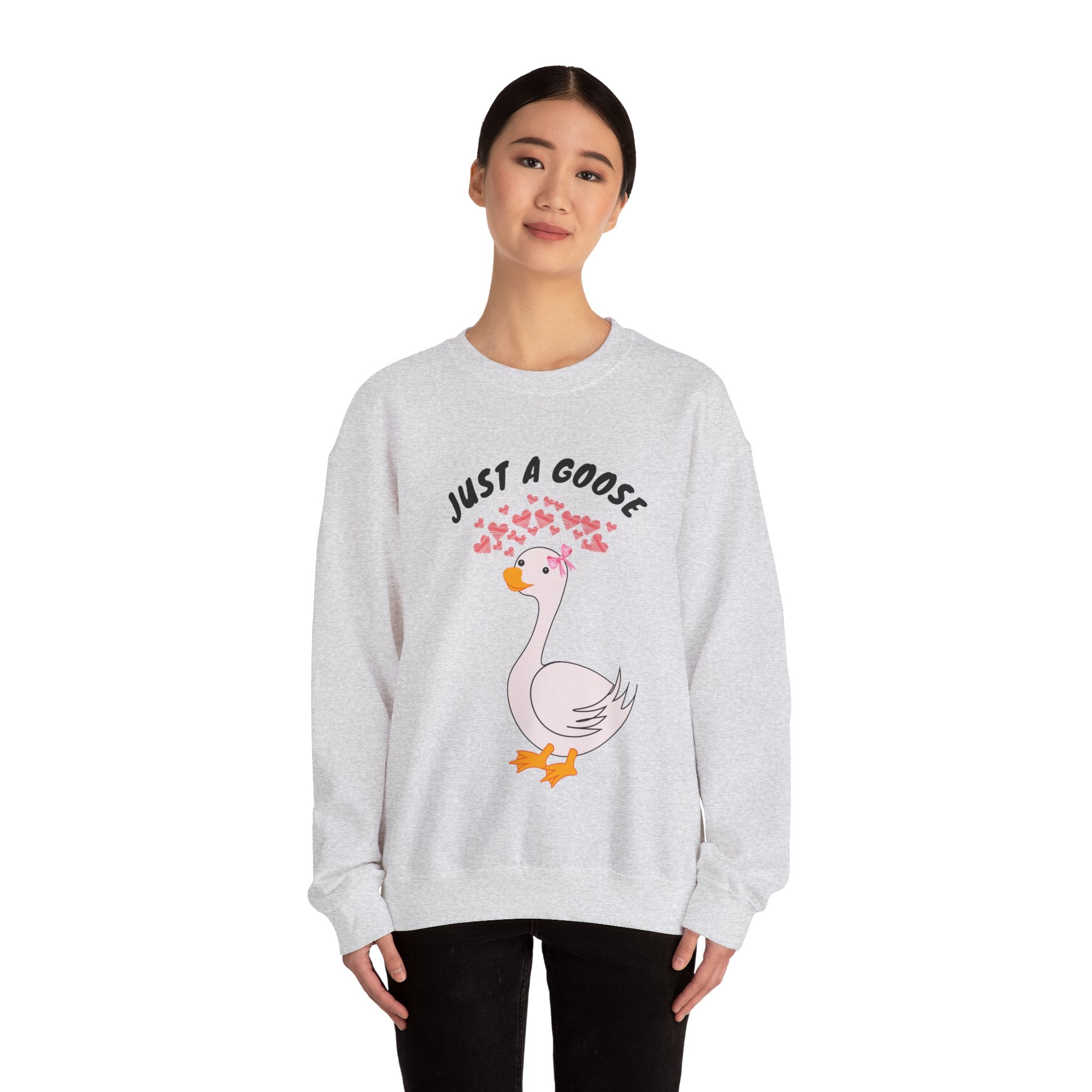Person wearing a Ash sweatshirt with a graphic of a goose and text 'Just a Goose' on a white background