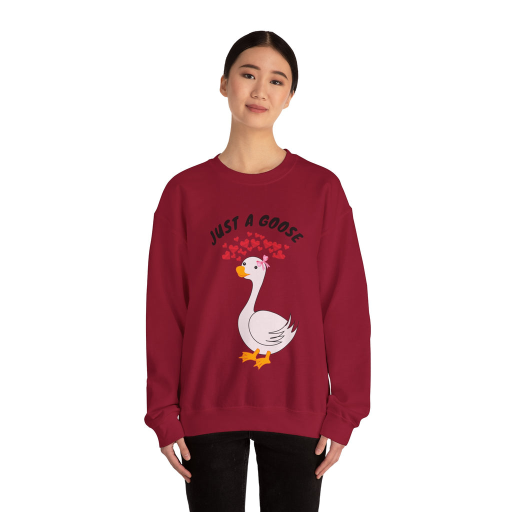 Person wearing a Cardinal red sweatshirt with a goose graphic and text on a white background
