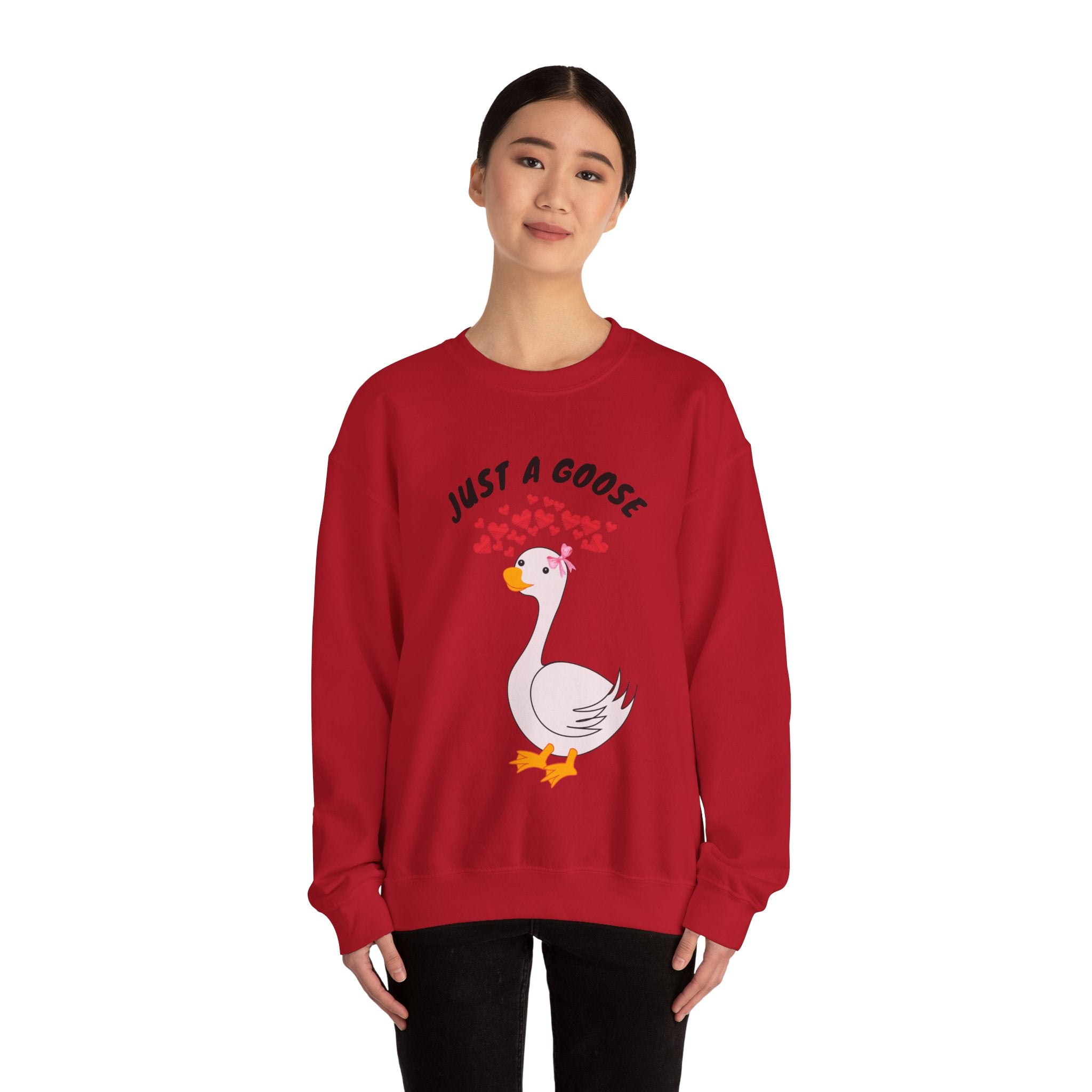 Person wearing a Cherry red sweatshirt with a goose graphic and text on a white background