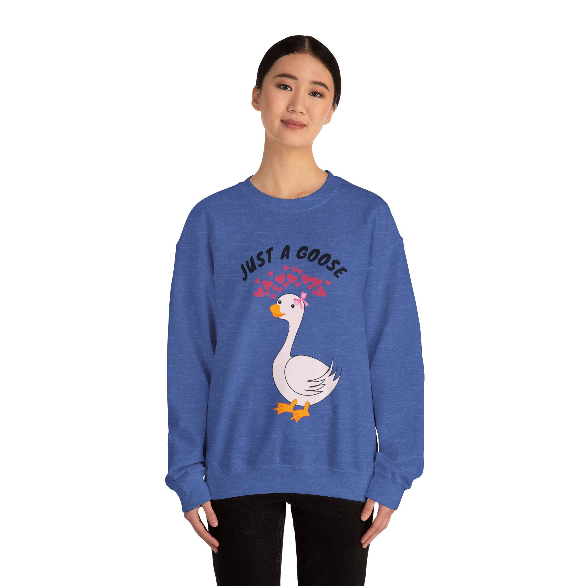 Person wearing a Heather Sport Royal sweatshirt with a goose graphic and text on a white background