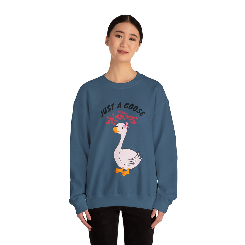 Person wearing an Indigo blue sweatshirt with a goose graphic and text on a white background