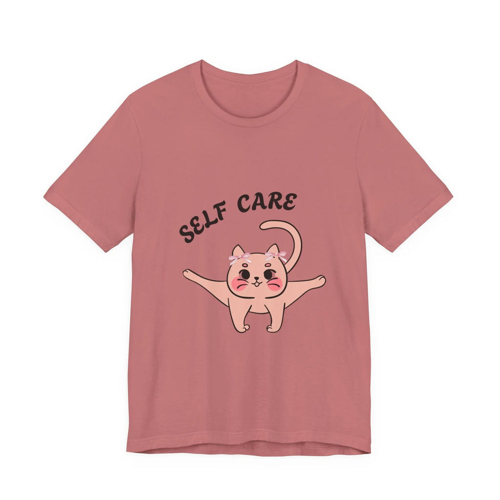 Mauve t-shirt with a cartoon cat and 'Self Care' text on a white background