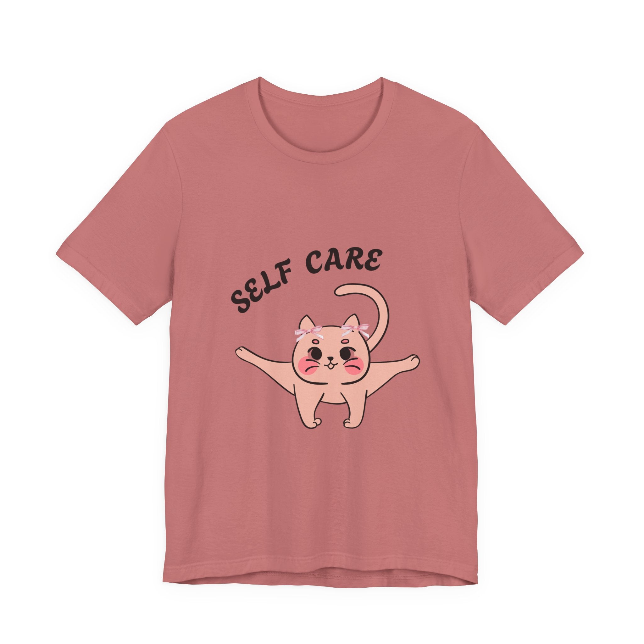 Mauve t-shirt with a cartoon cat and 'Self Care' text on a white background
