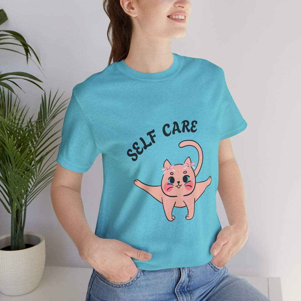 Person wearing a Turquoise t-shirt with a cartoon cat and 'SELF CARE' text.