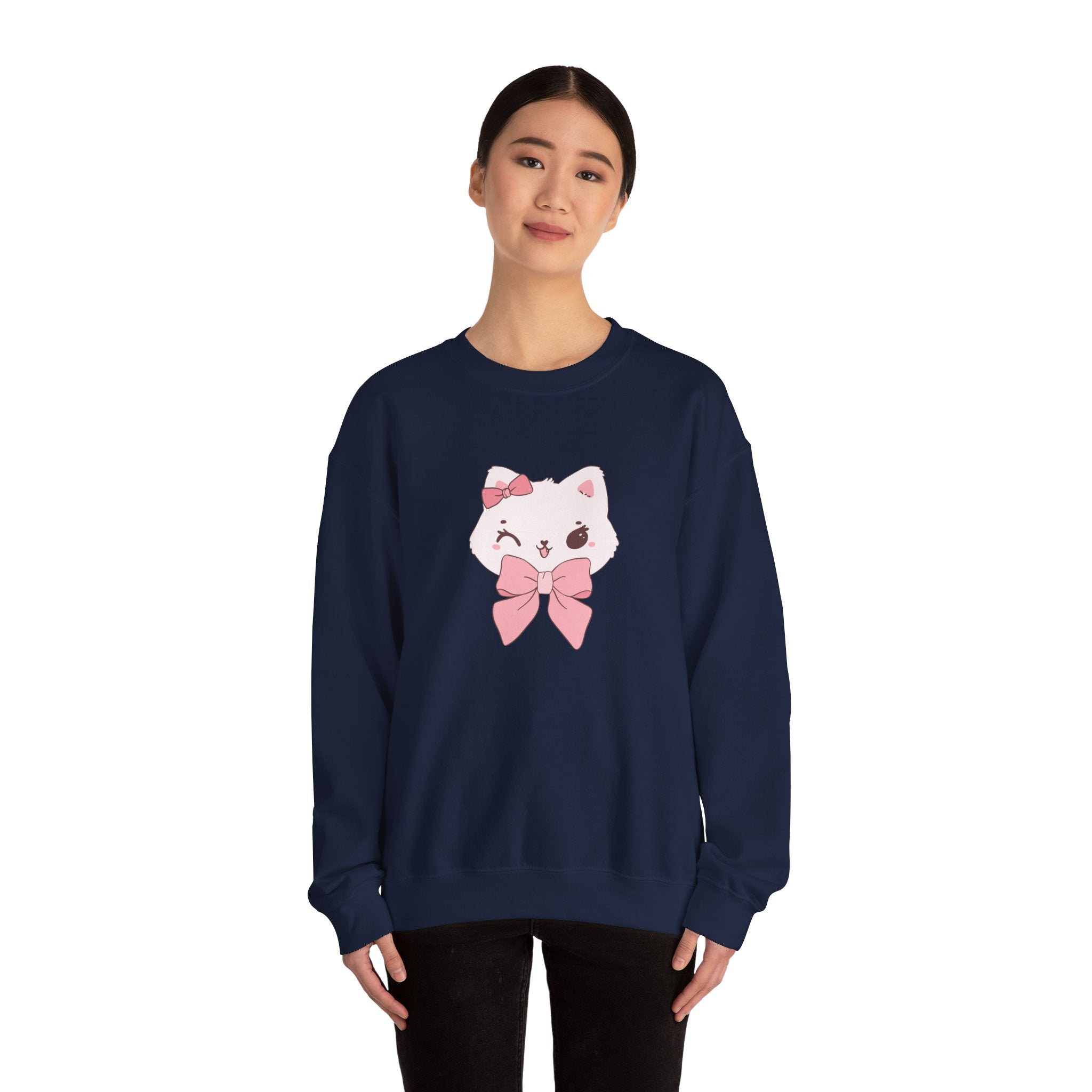 Person wearing a navy sweatshirt with a cartoon cat design on a white background