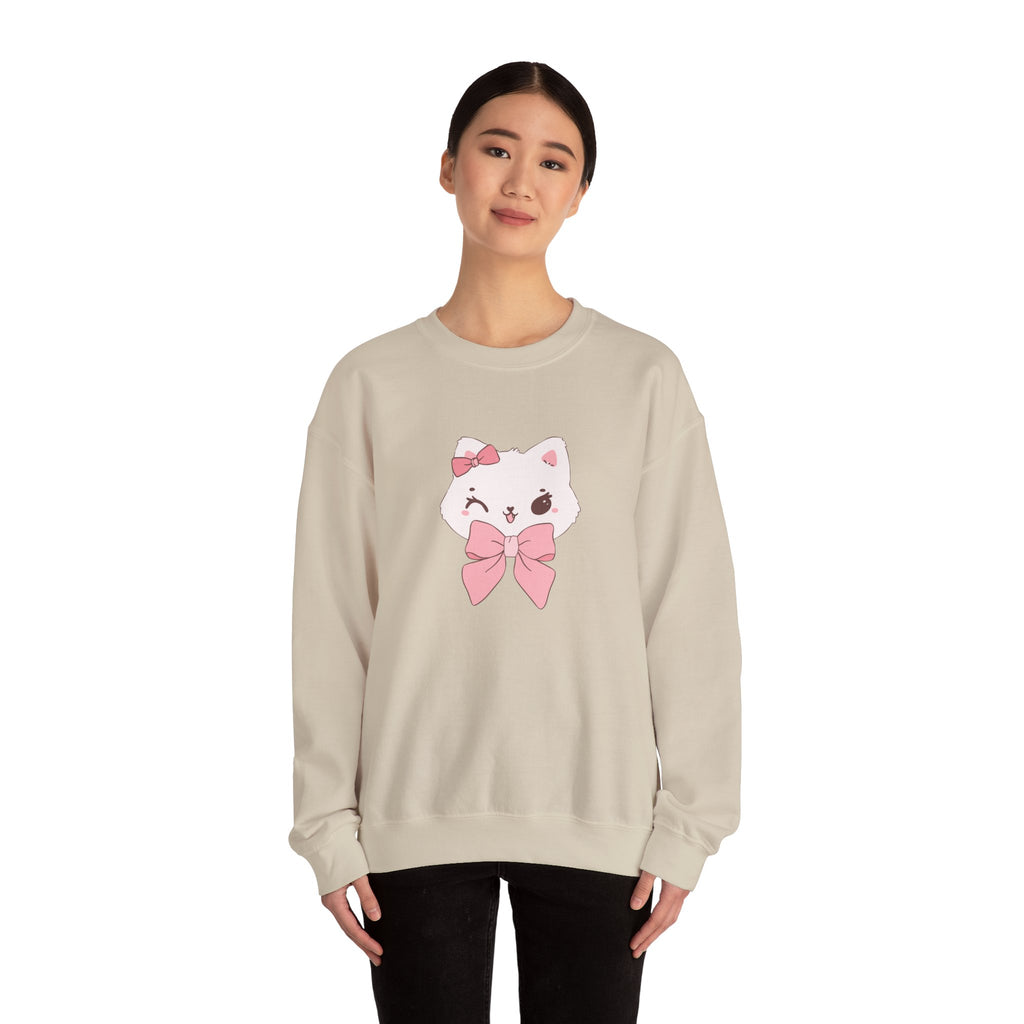 Person wearing a Sand sweatshirt with a cartoon cat design on a white background