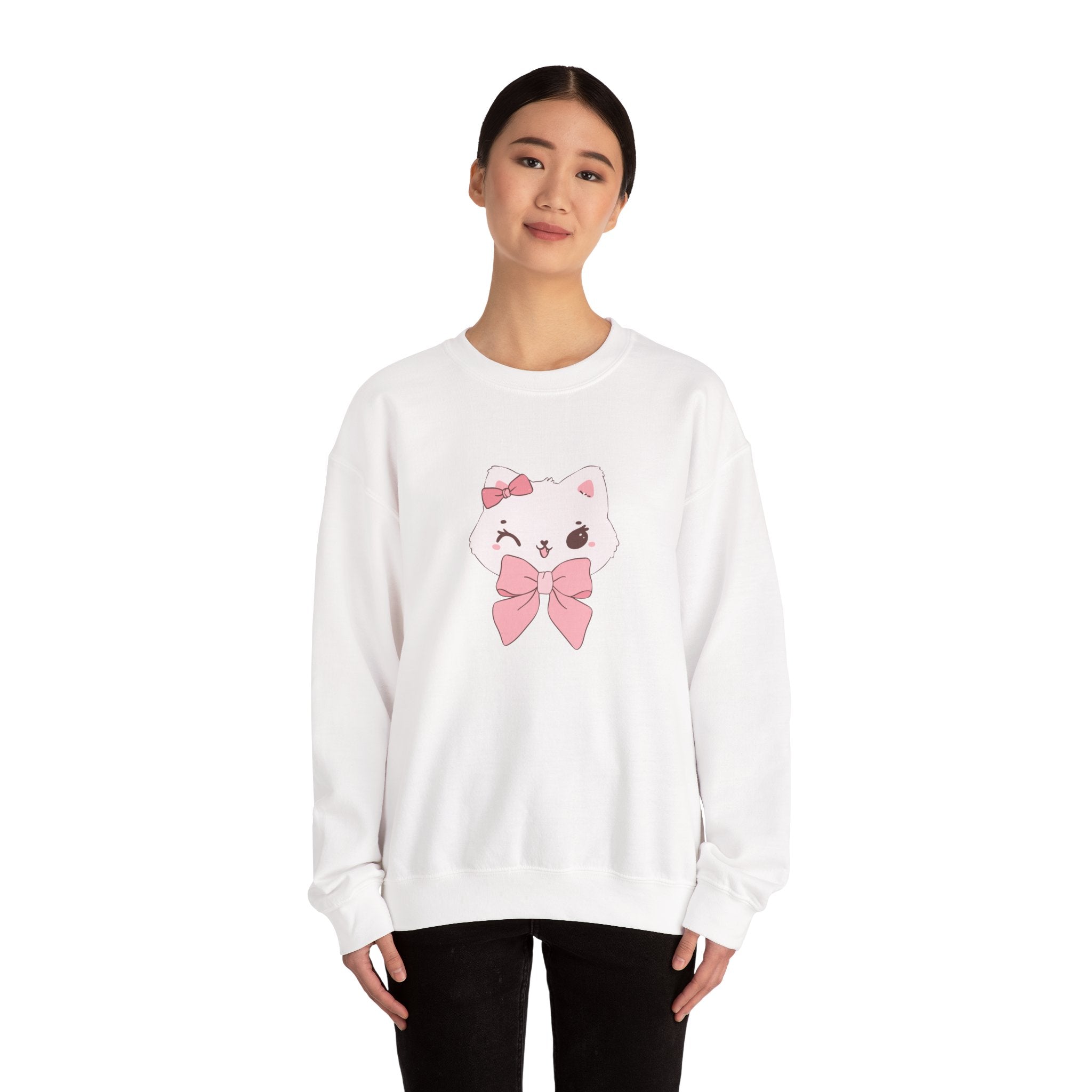Person wearing a white sweatshirt with a cartoon cat design and pink bow on a white background