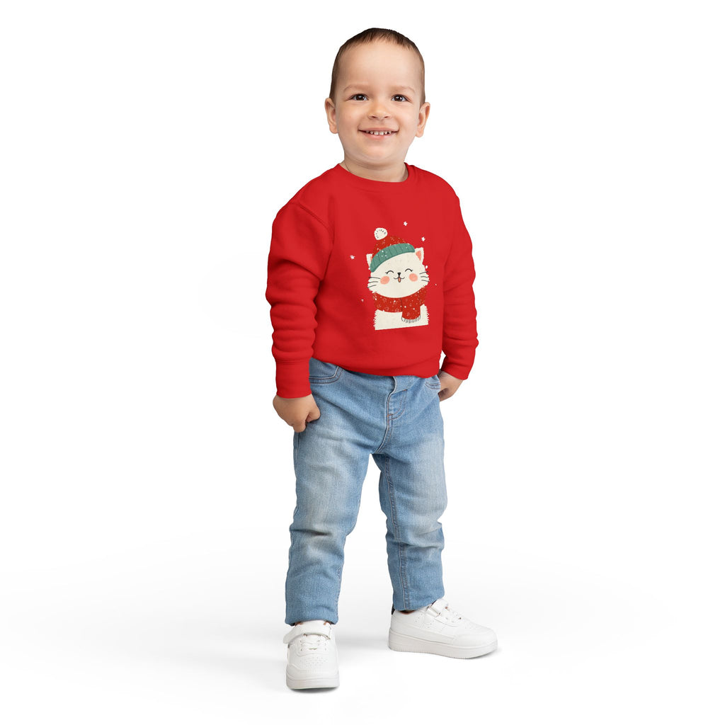 Child wearing a red sweater with a cat design on a white background
