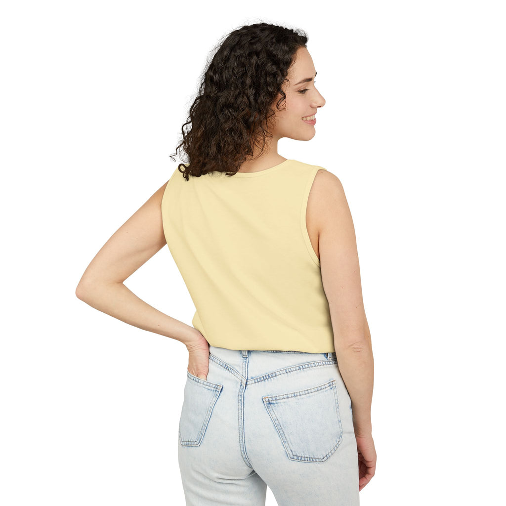 Woman wearing a Butter sleeveless top and light blue jeans on a white background