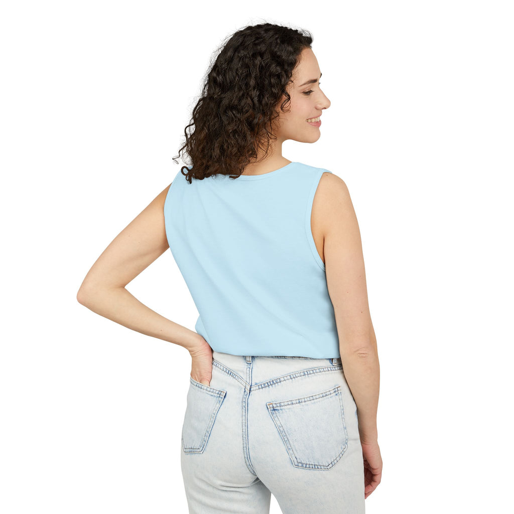 Woman wearing a Chambray sleeveless top and light gray jeans on a white background
