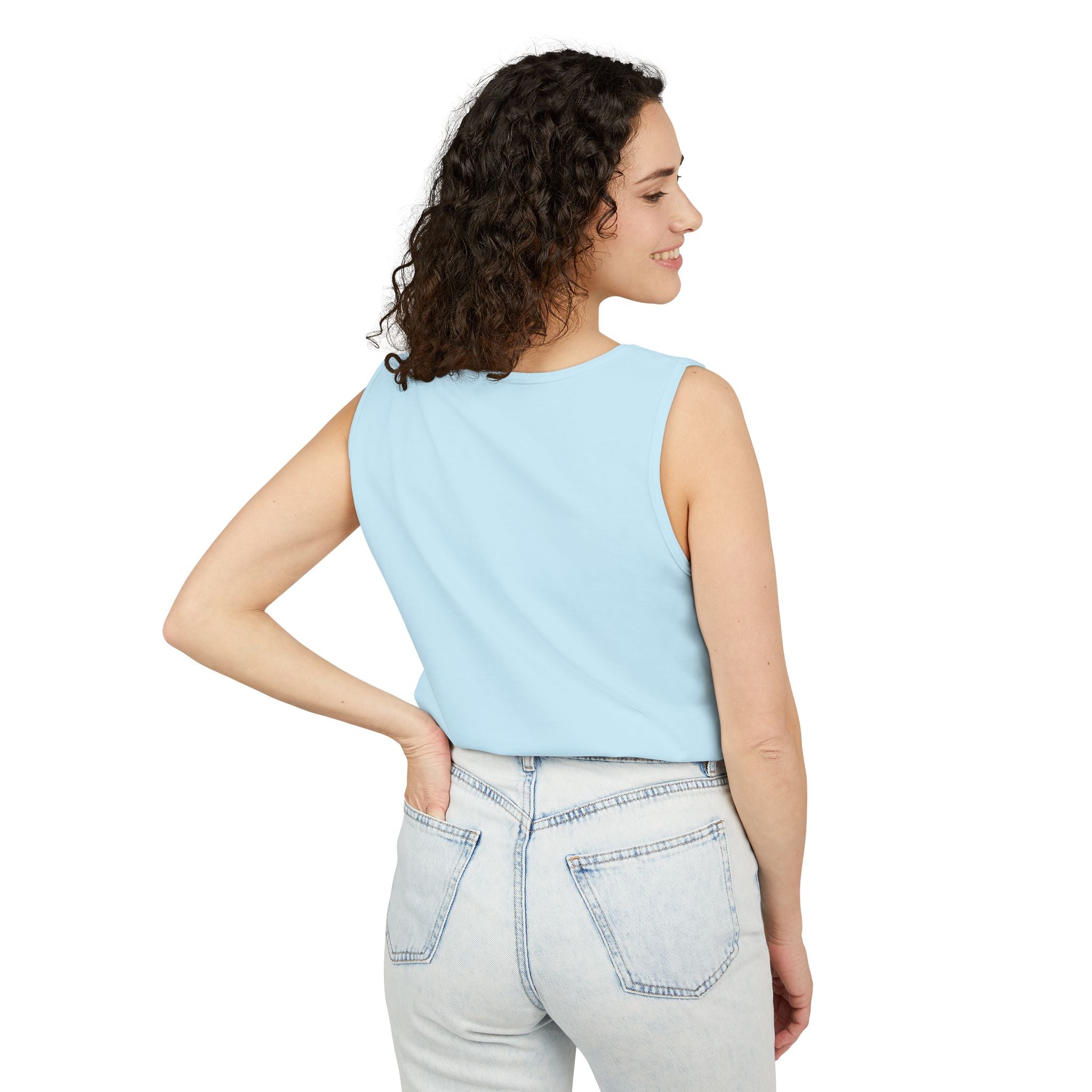 Woman wearing a Chambray sleeveless top and light gray jeans on a white background