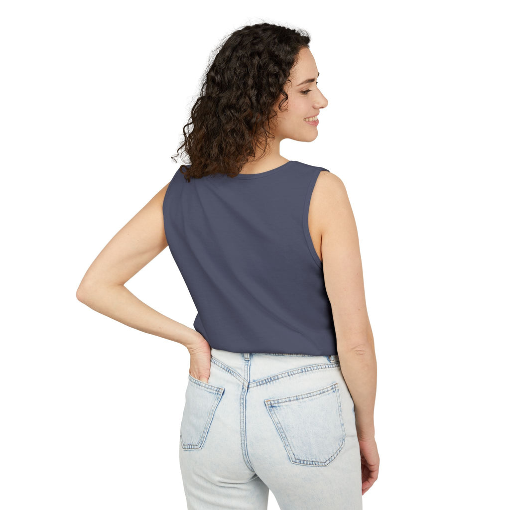 Woman wearing a sleeveless Denim top and light blue jeans on a white background