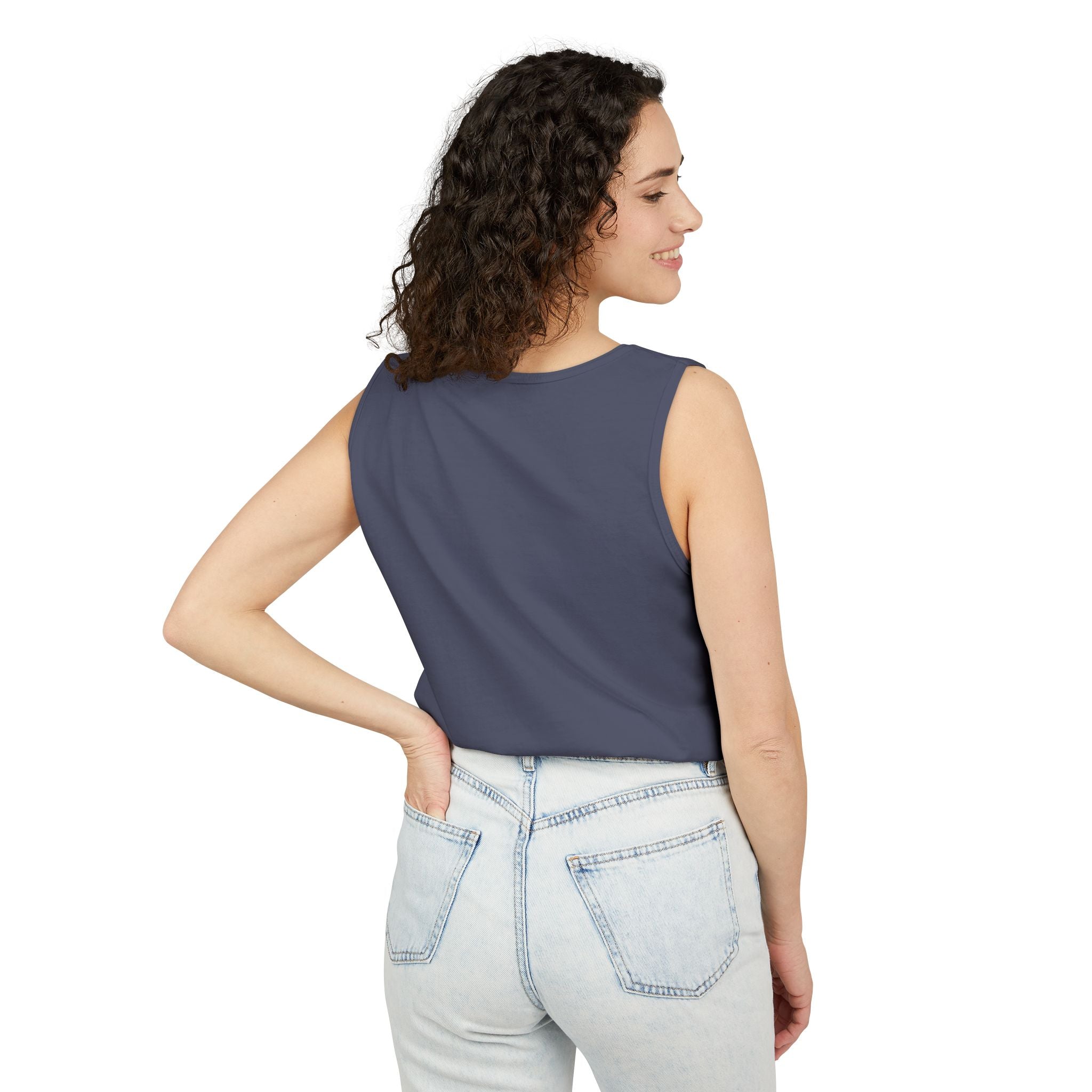 Woman wearing a sleeveless Denim top and light blue jeans on a white background