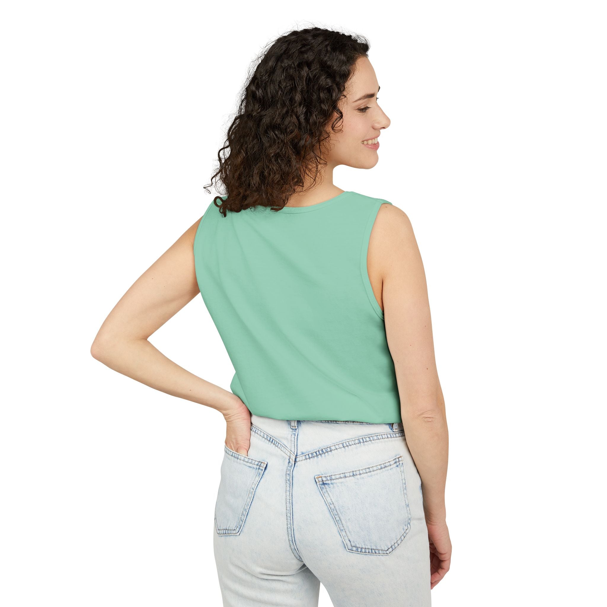 Woman wearing a Island Reef sleeveless top and light blue jeans on a white background