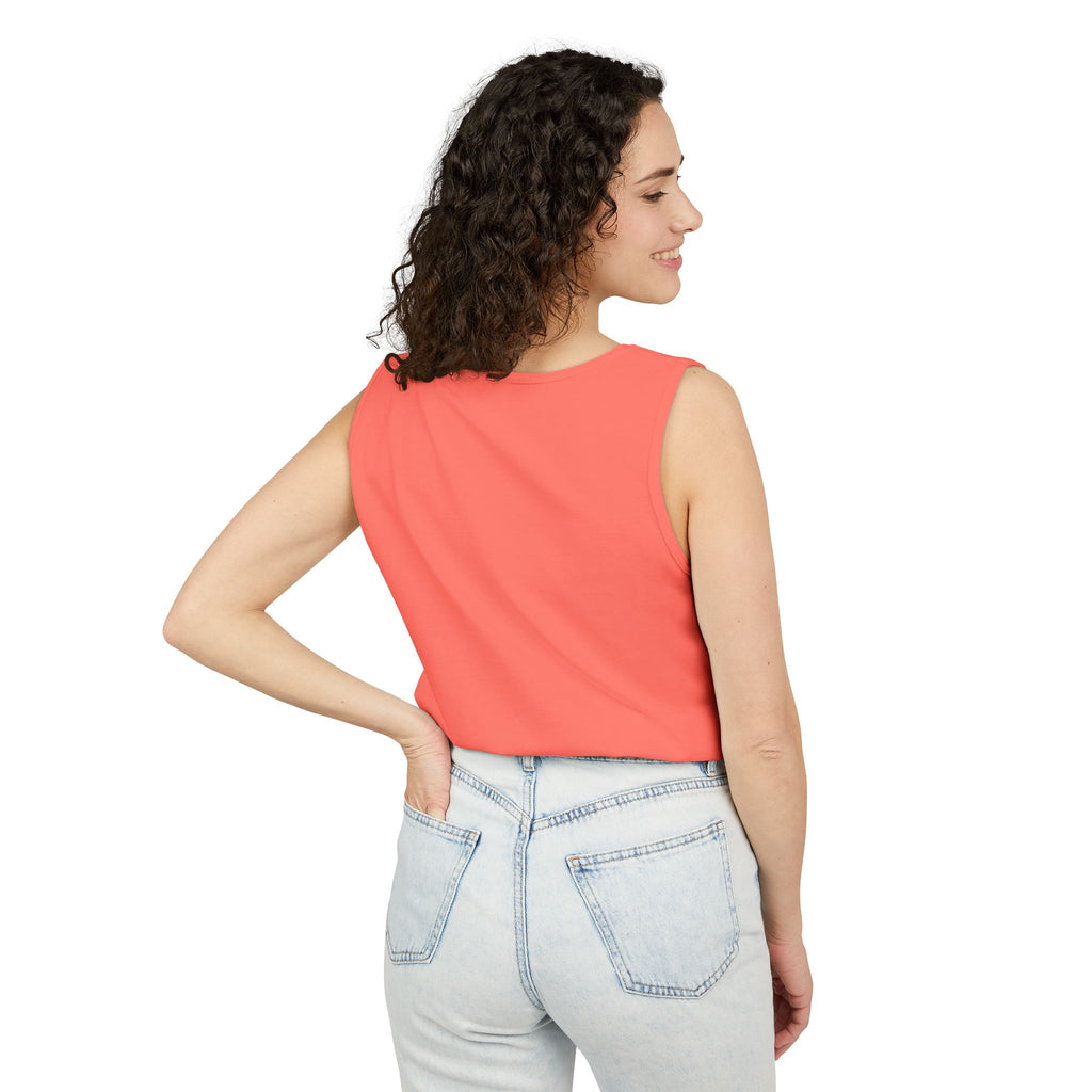 Woman wearing a Neon red orange sleeveless top and light blue jeans on a white background