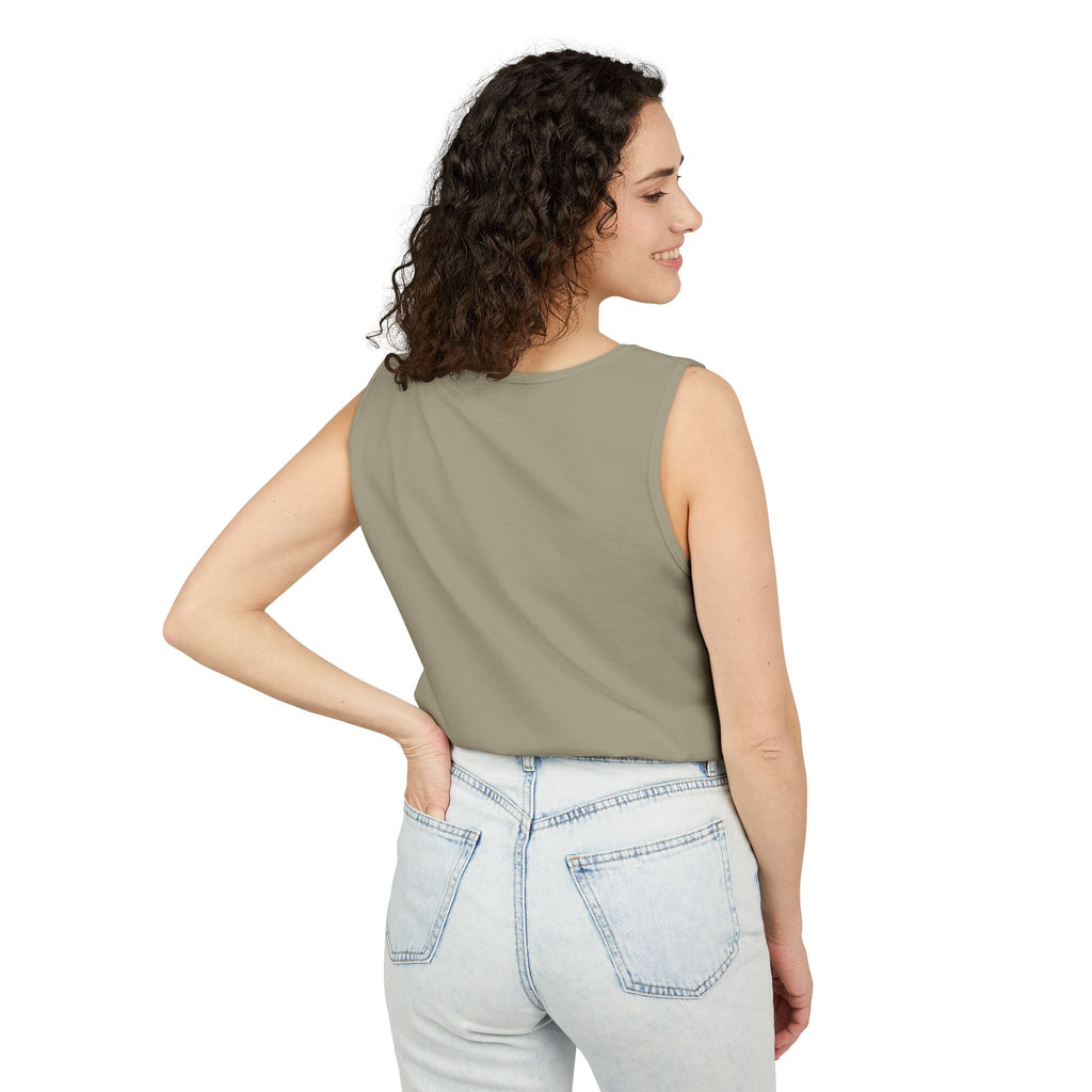 Woman wearing a Sandstone sleeveless top and light blue jeans on a white background