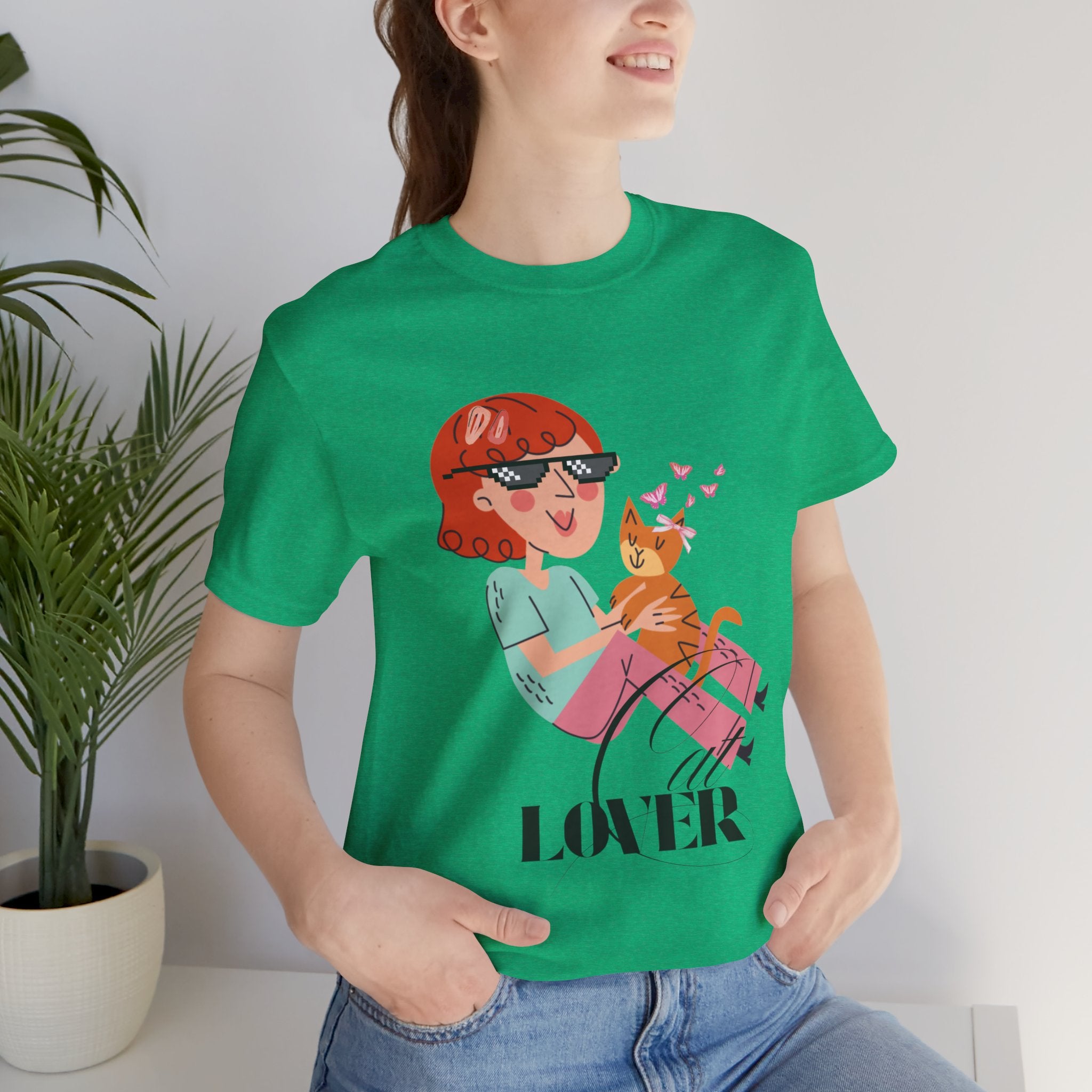 Person wearing a Heather Kelly t-shirt with a graphic design and the word 'Cat LOVER'.