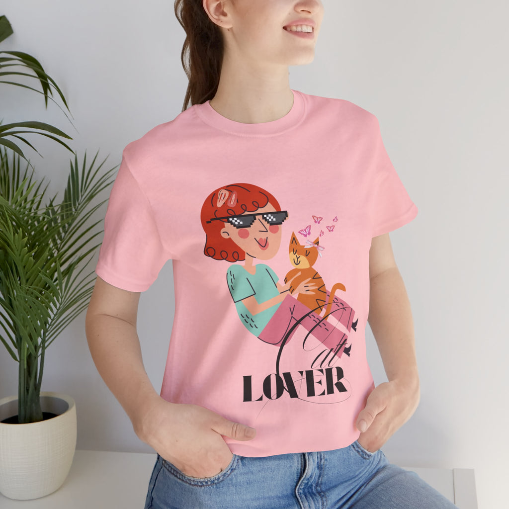 Person wearing a pink t-shirt with a graphic design of a woman holding a cat and the word 'Cat LOVER'.