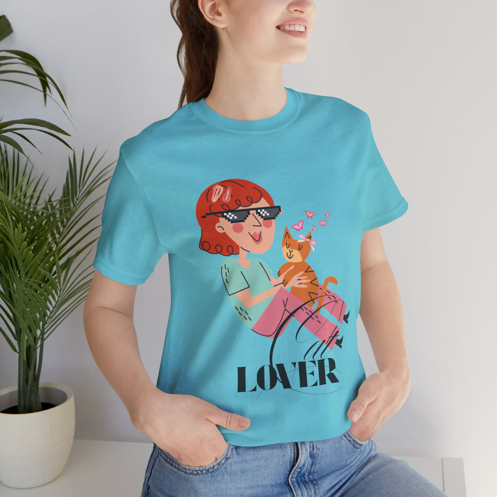 Person wearing a Turquoise t-shirt with a graphic design and the word 'LOVER'.