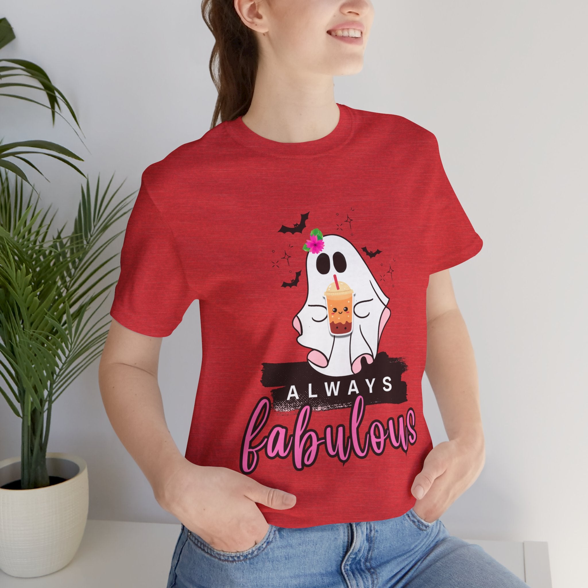 Person wearing a heather red t-shirt with a ghost graphic and 'Always fabulous' text, standing indoors.
