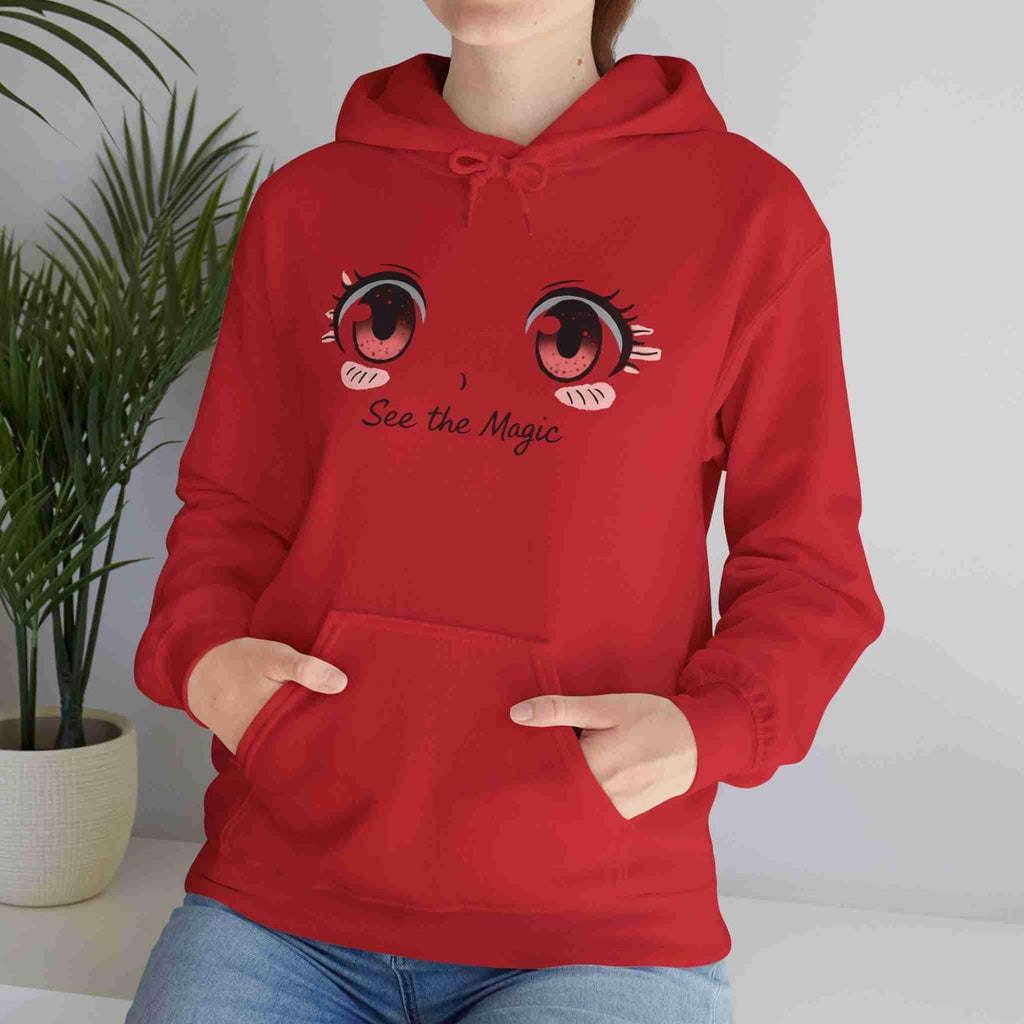 Person wearing a red hoodie with cartoon eyes and 'See the Magic' text, standing indoors.