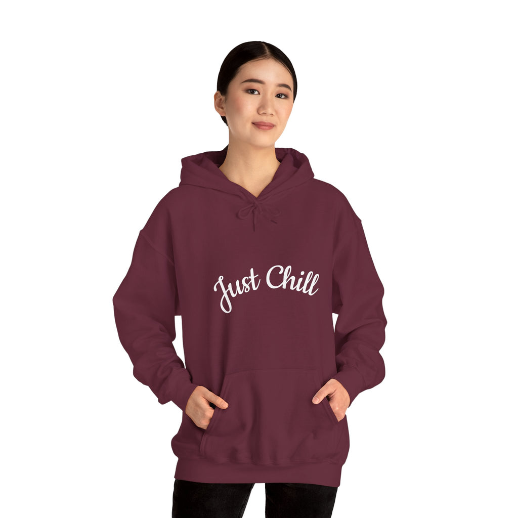 Maroon hoodie with 'Just Chill' text worn by a person on a white background