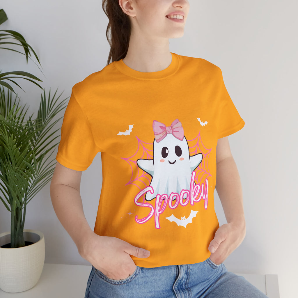 Person wearing a Gold t-shirt with a ghost graphic and 'Spooky' text, standing indoors.