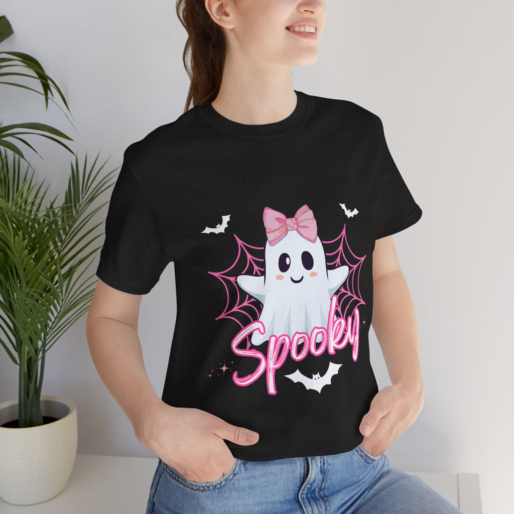 Person wearing a Heather black t-shirt with a ghost design and 'Spooky' text, standing indoors.