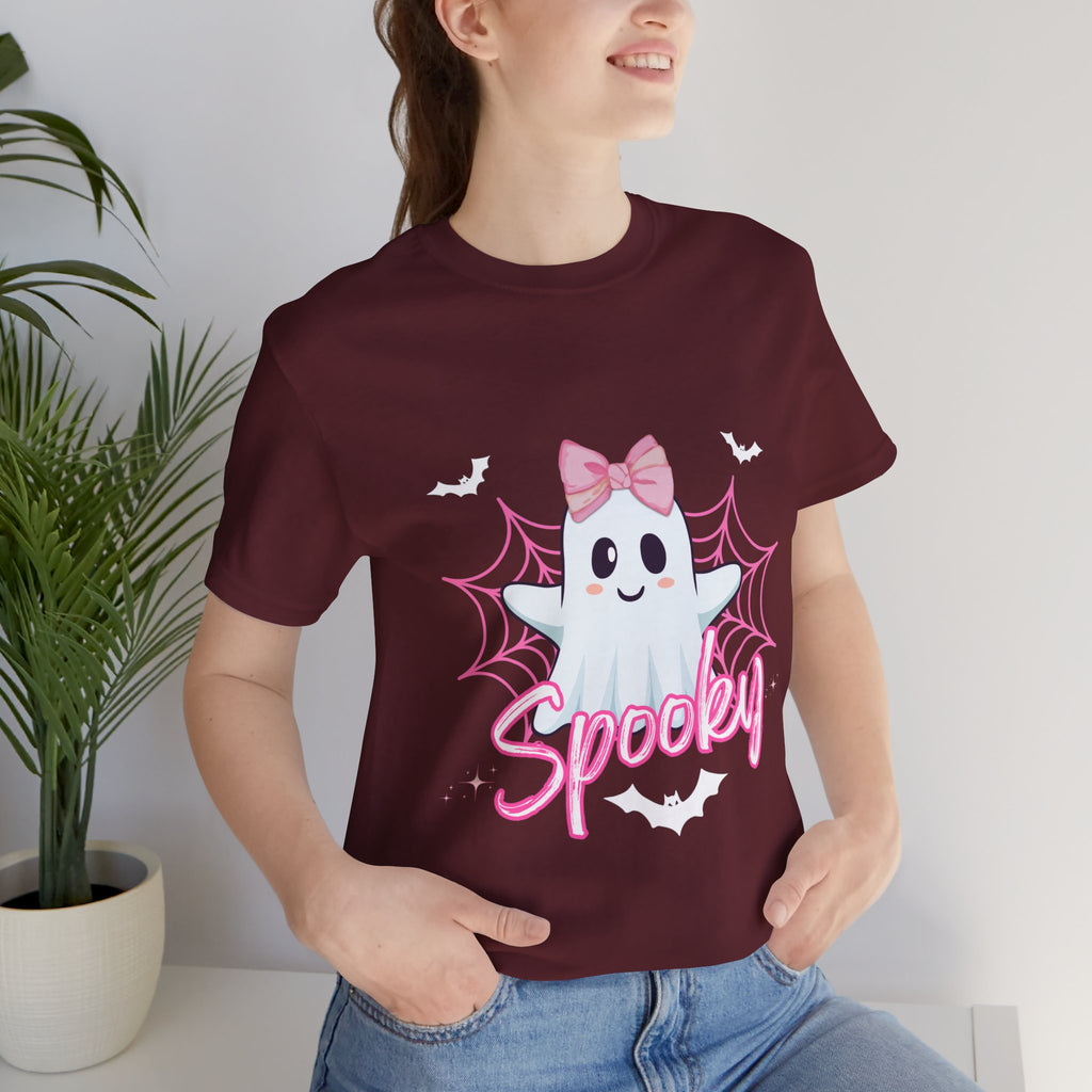 Person wearing a maroon t-shirt with a ghost design and 'Spooky' text, standing indoors.