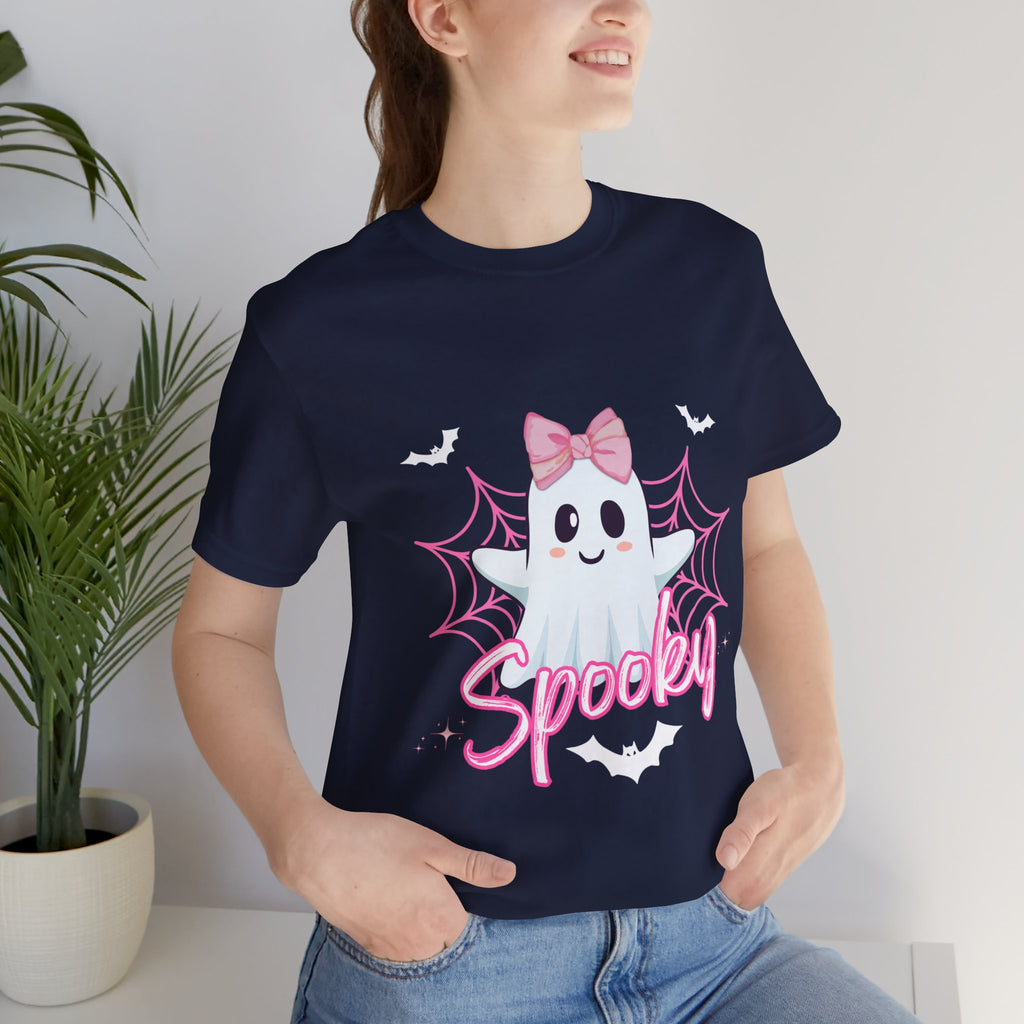 Person wearing a navy t-shirt with a ghost design and 'Spooky' text, standing indoors.