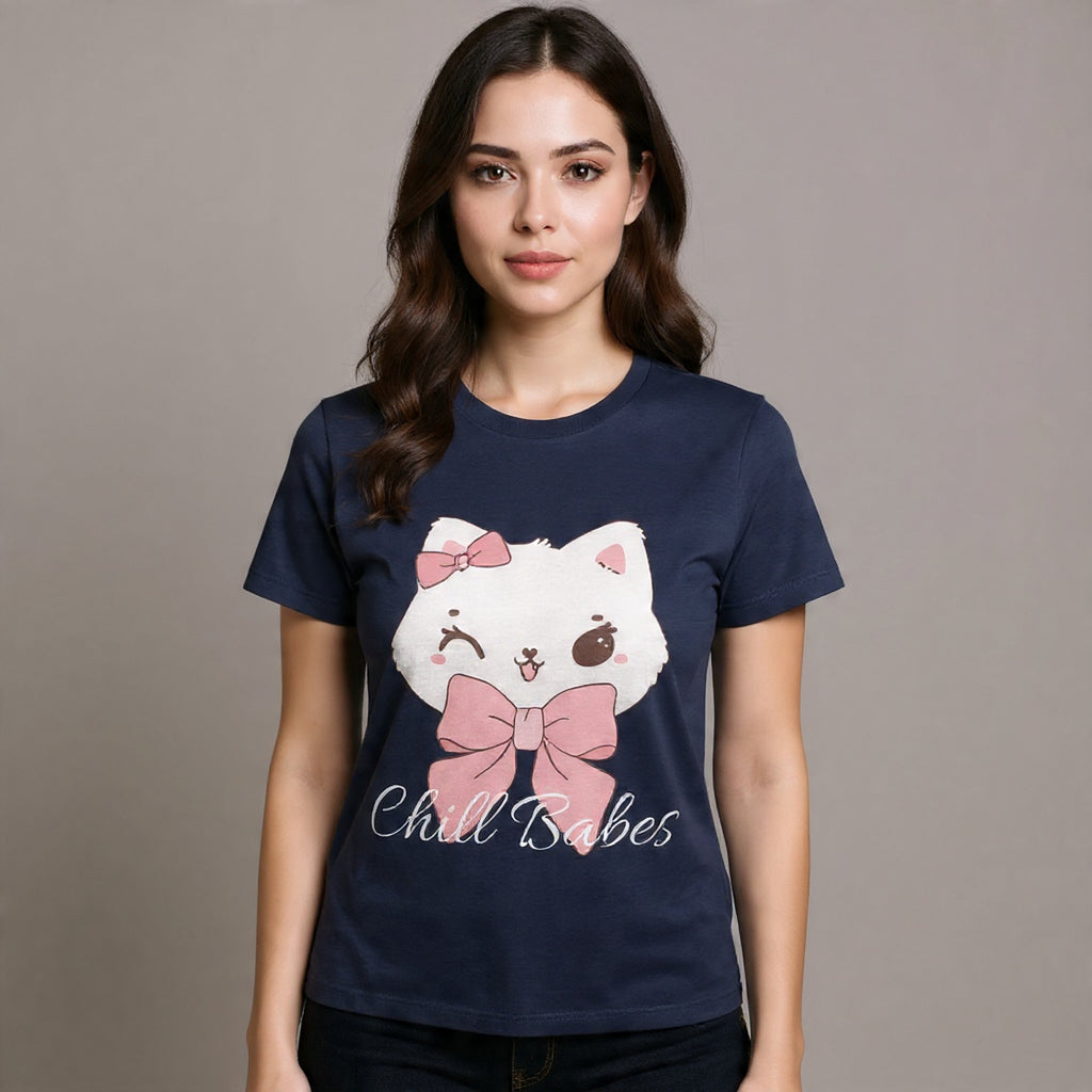 Woman wearing a navy t-shirt with a cartoon cat design and text on a plain background