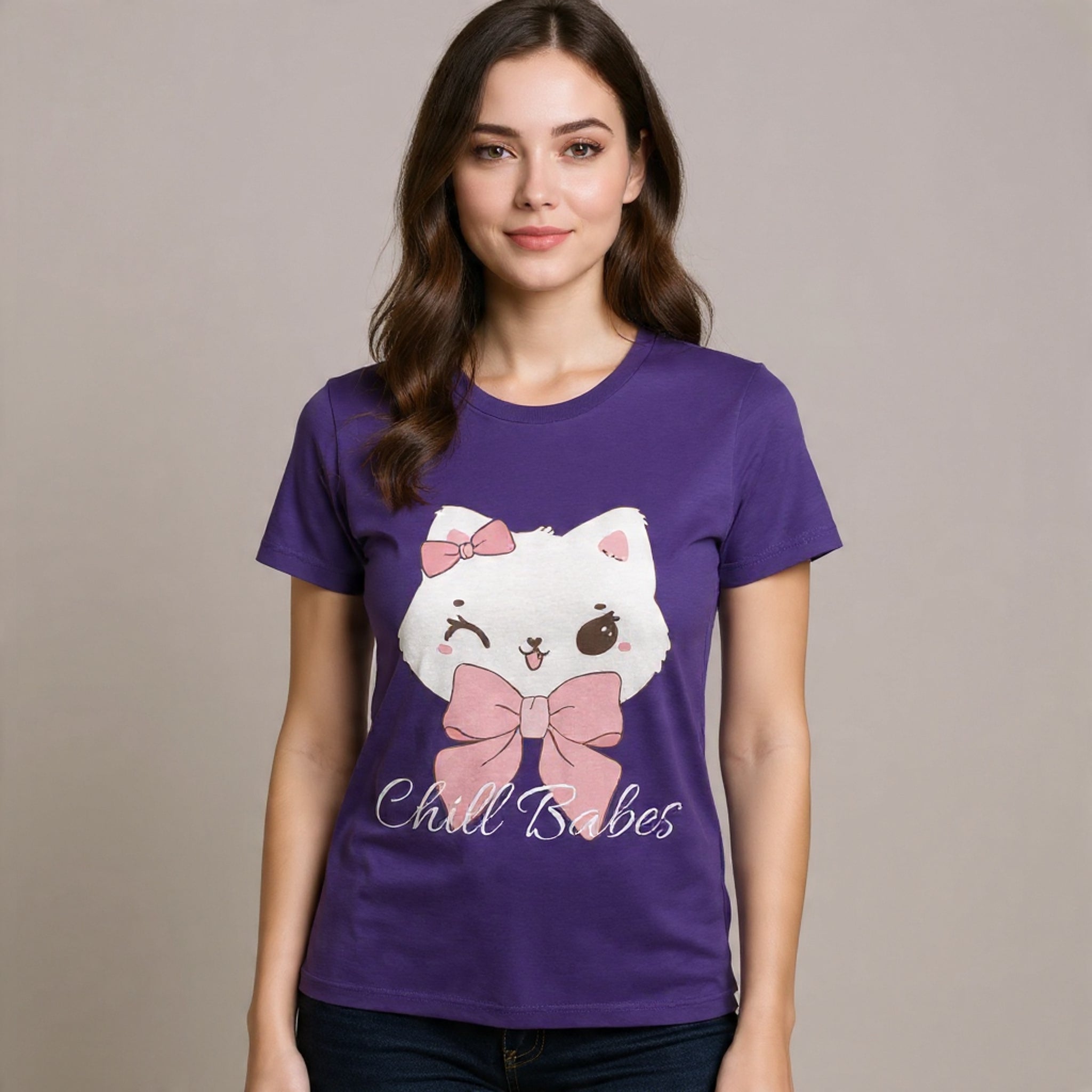 Woman wearing a True purple t-shirt with a cartoon cat design and text on a plain background