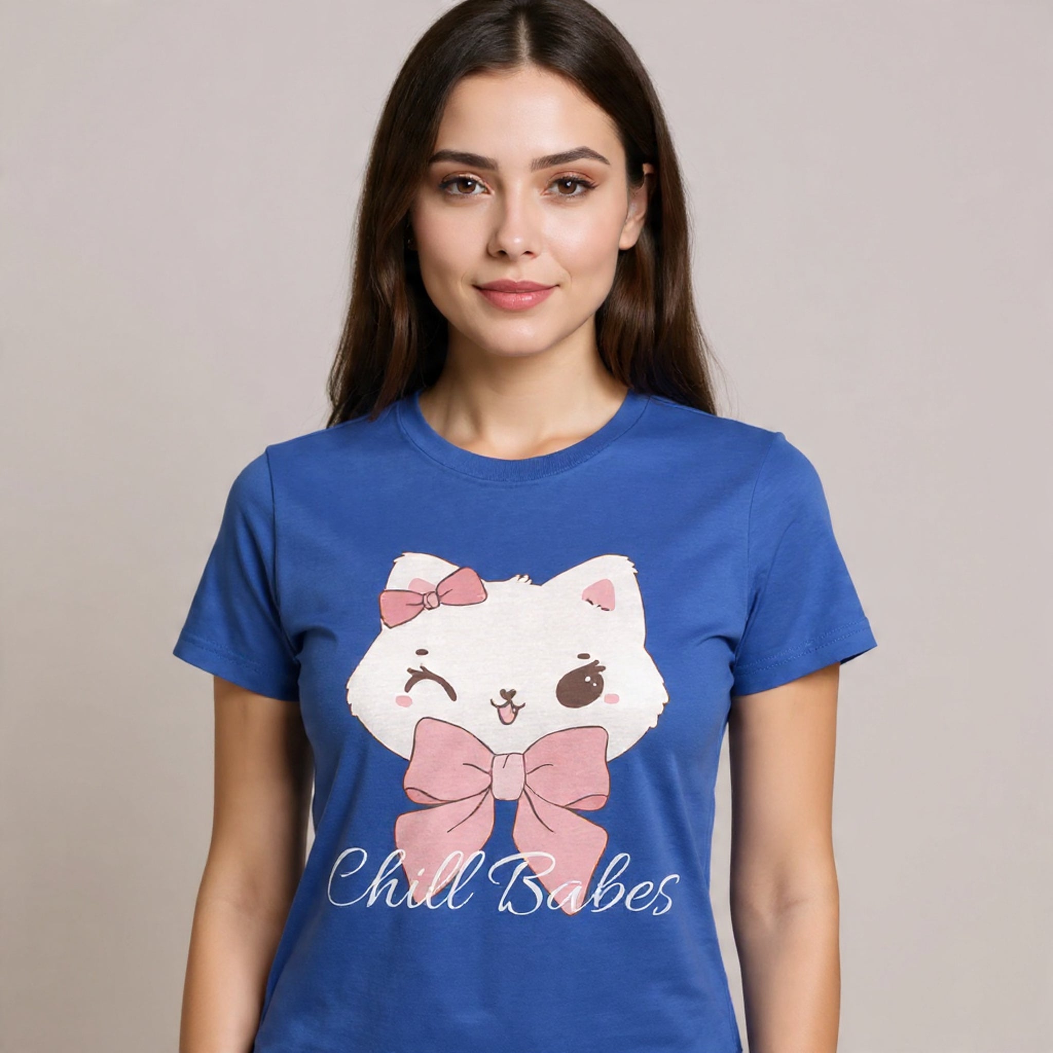 Woman wearing a True Royal t-shirt with a cartoon cat design and text on a beige background