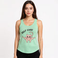Woman wearing a Solid Mint tank top with a pink cat illustration and 'SELF CARE' text on a white background