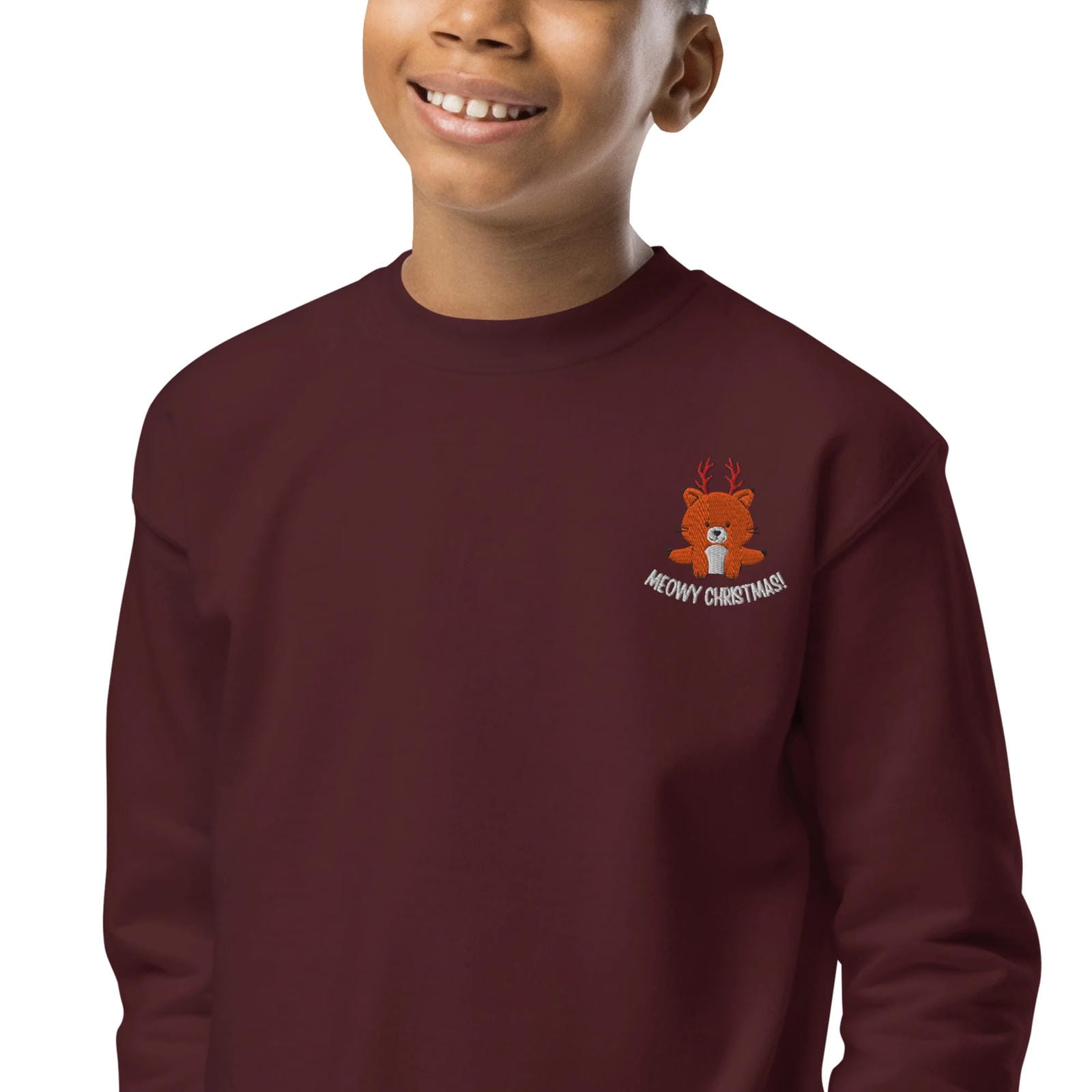 Child wearing a maroon sweatshirt with a teddy bear design and text on a white background