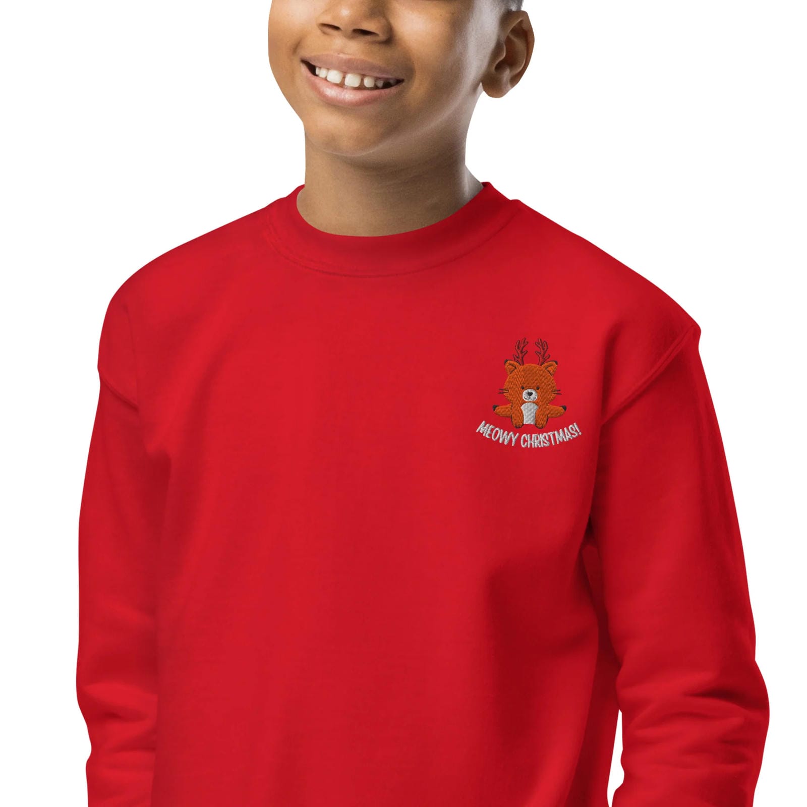 Child wearing a red sweatshirt with a Christmas-themed design on a white background